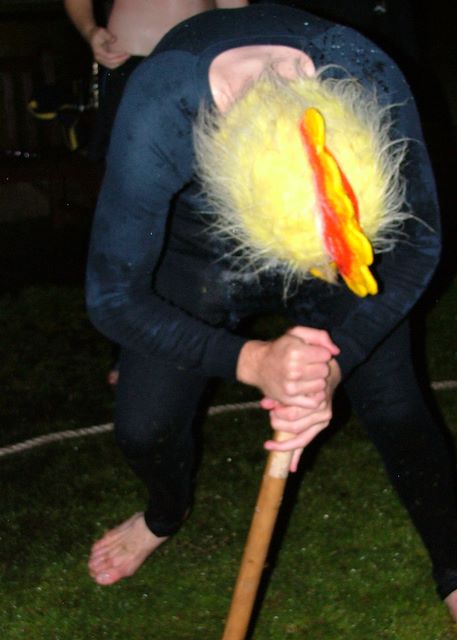 A chicken in children's pyjamas plays stumpy.